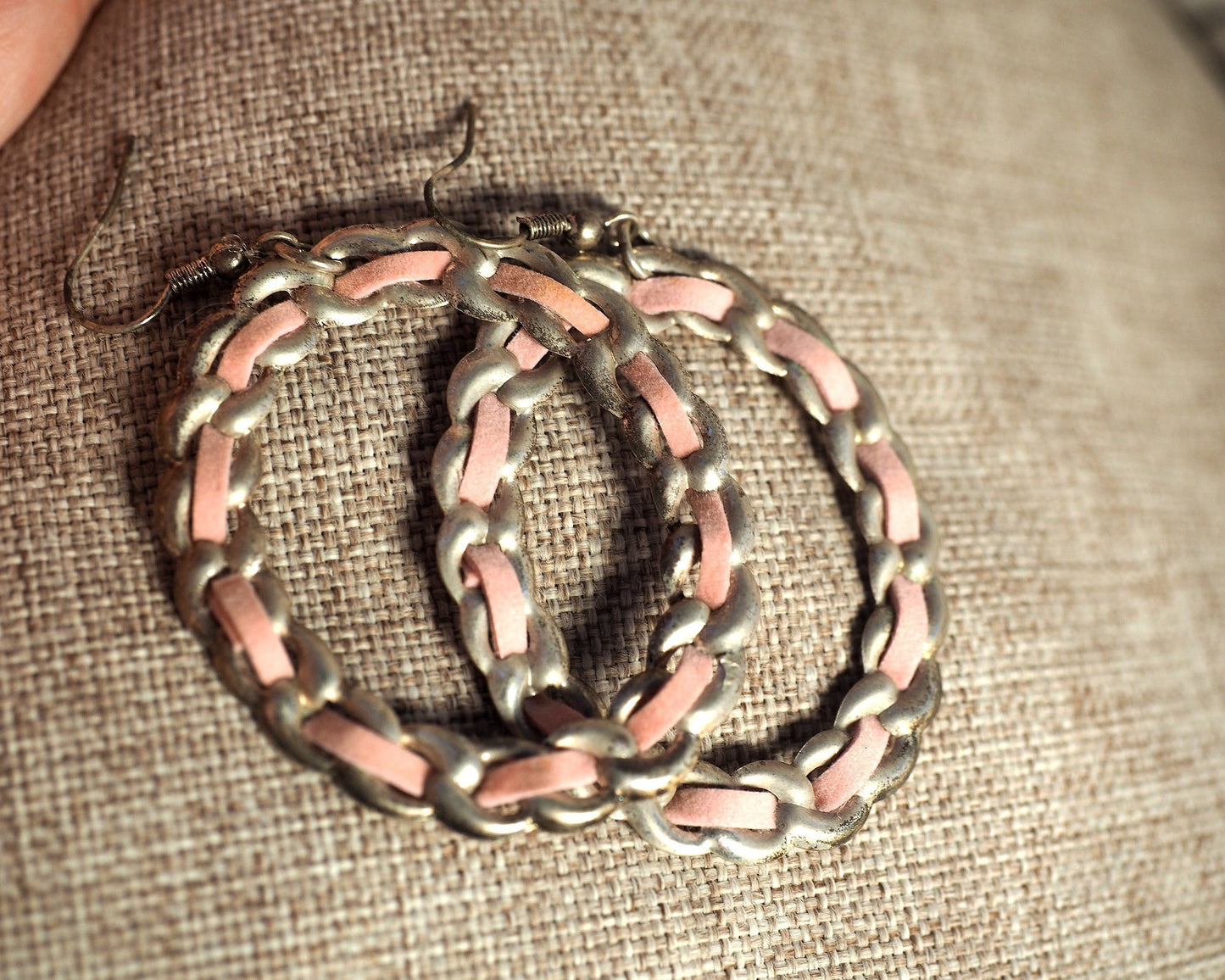 1970s pink enamel chainlink hoop earrings resting on fingertips, showing scale and 2 3/4 inch drop length