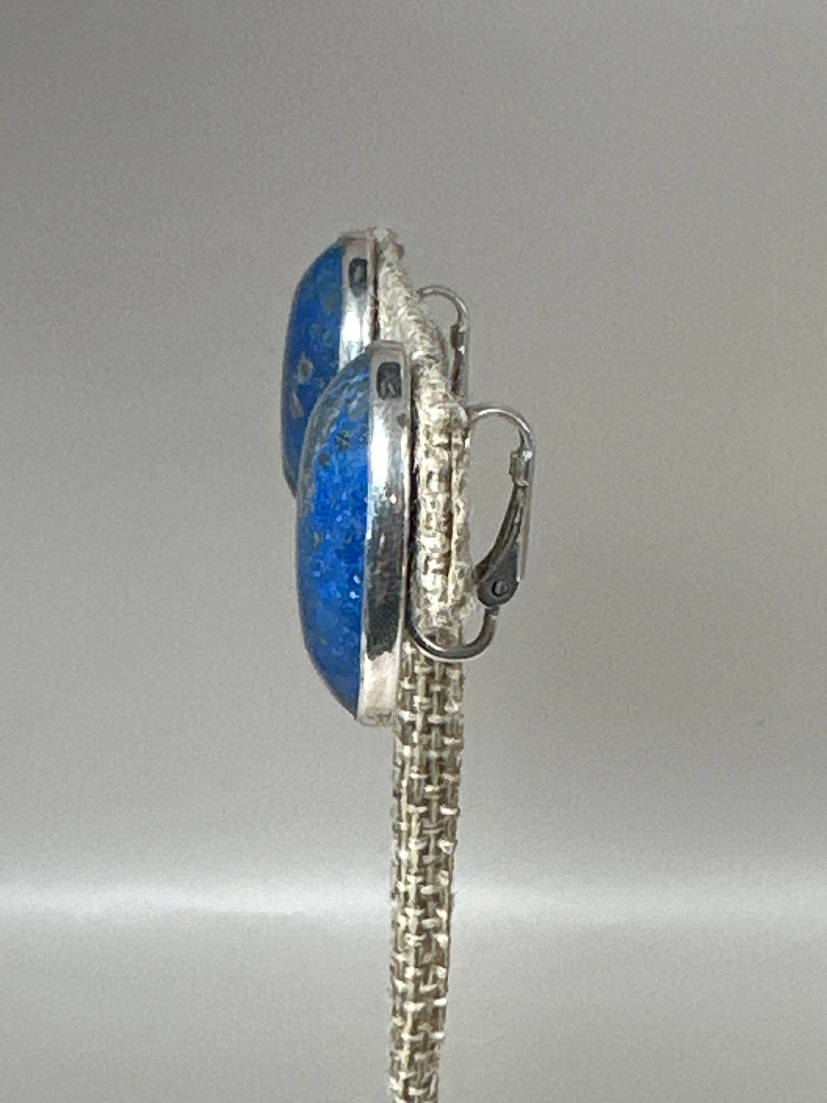 Side profile view showing bezel setting depth and hinged clip mechanism with comfort pad