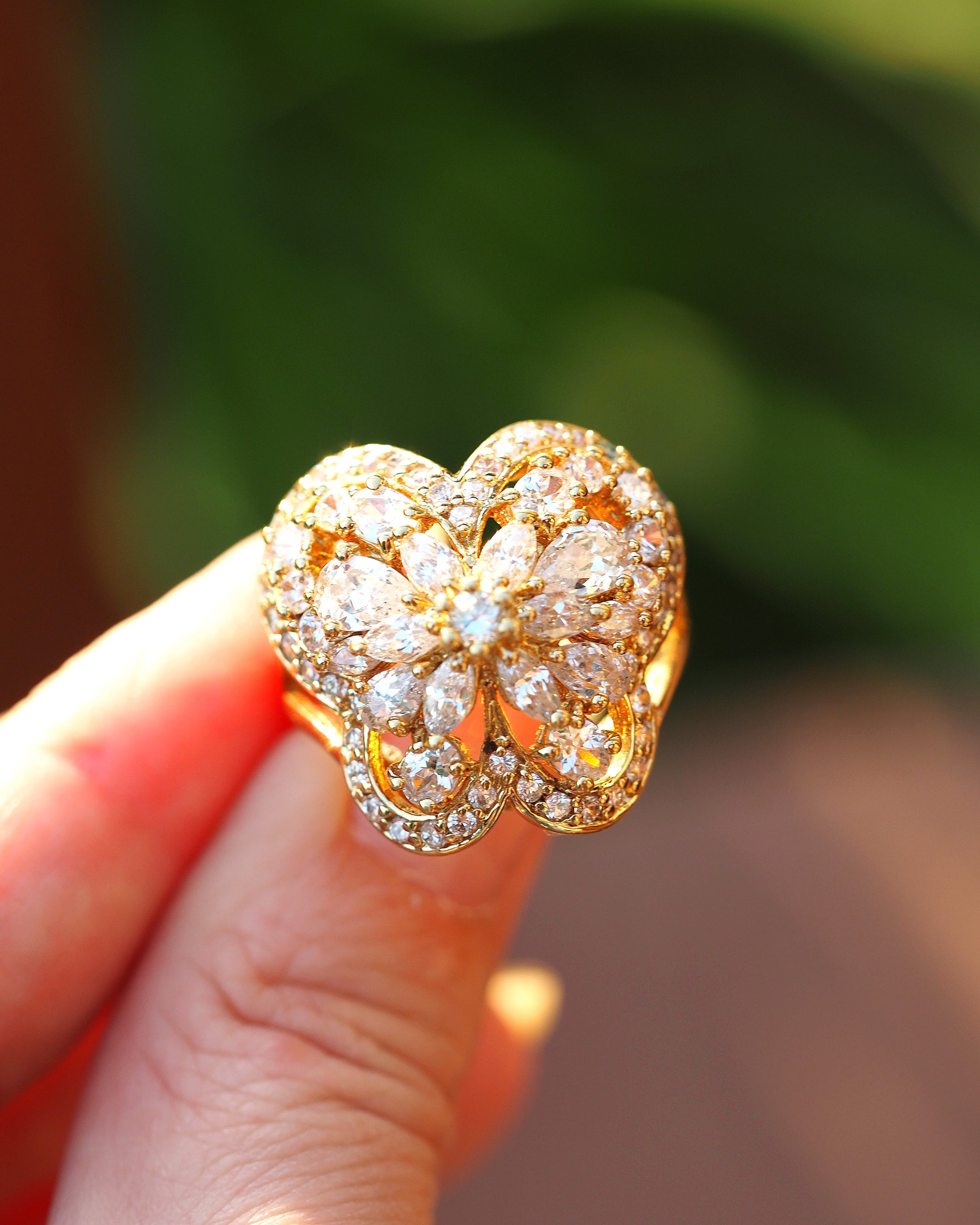 Gold vermeil butterfly ring held on fingertip showing scale, approximately 7/8 inch across