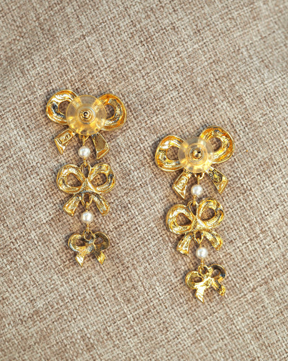 Earrings held in palm for scale, showing full 2.25-inch drop length