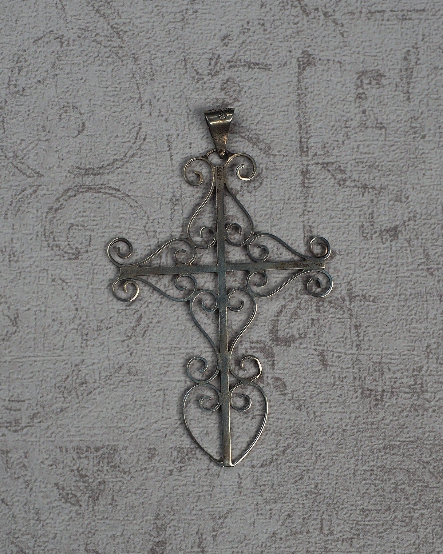 Vintage Taxco sterling silver openwork cross pendant with scrollwork, front view