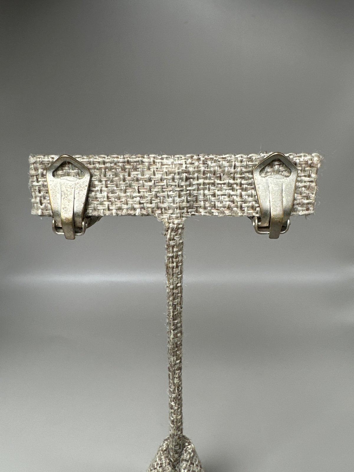 back view of both cameo clip earrings showing hinged paddle closures