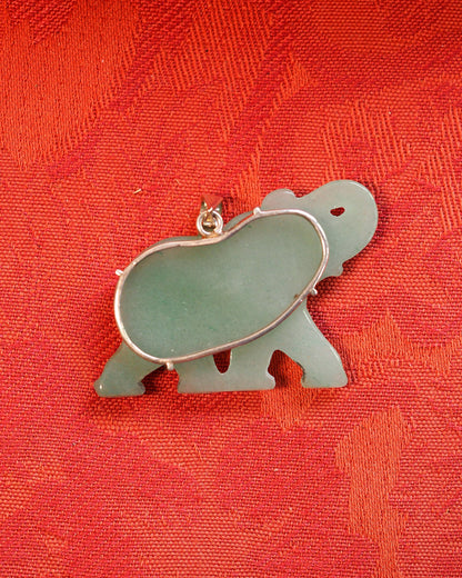 Back view of aventurine elephant pendant on red fabric, showing sterling silver prong mounts and natural color gradient in stone