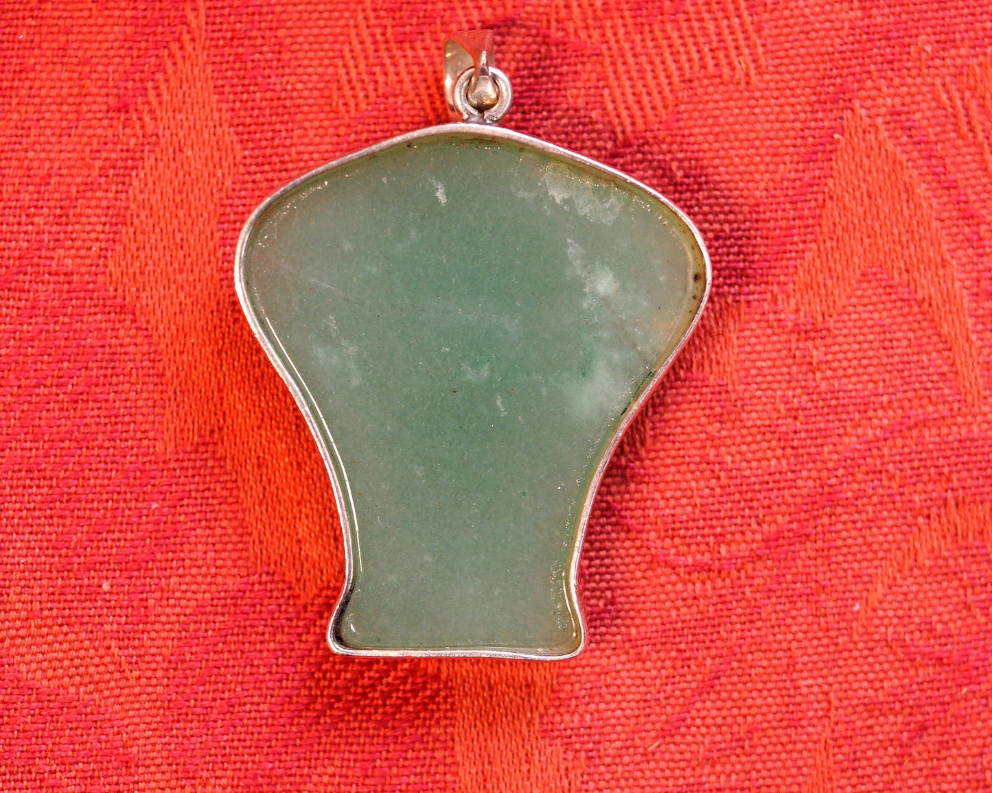 Back view of the aventurine elephant pendant showing smooth polished stone surface and sterling silver slide bail stamped 925
