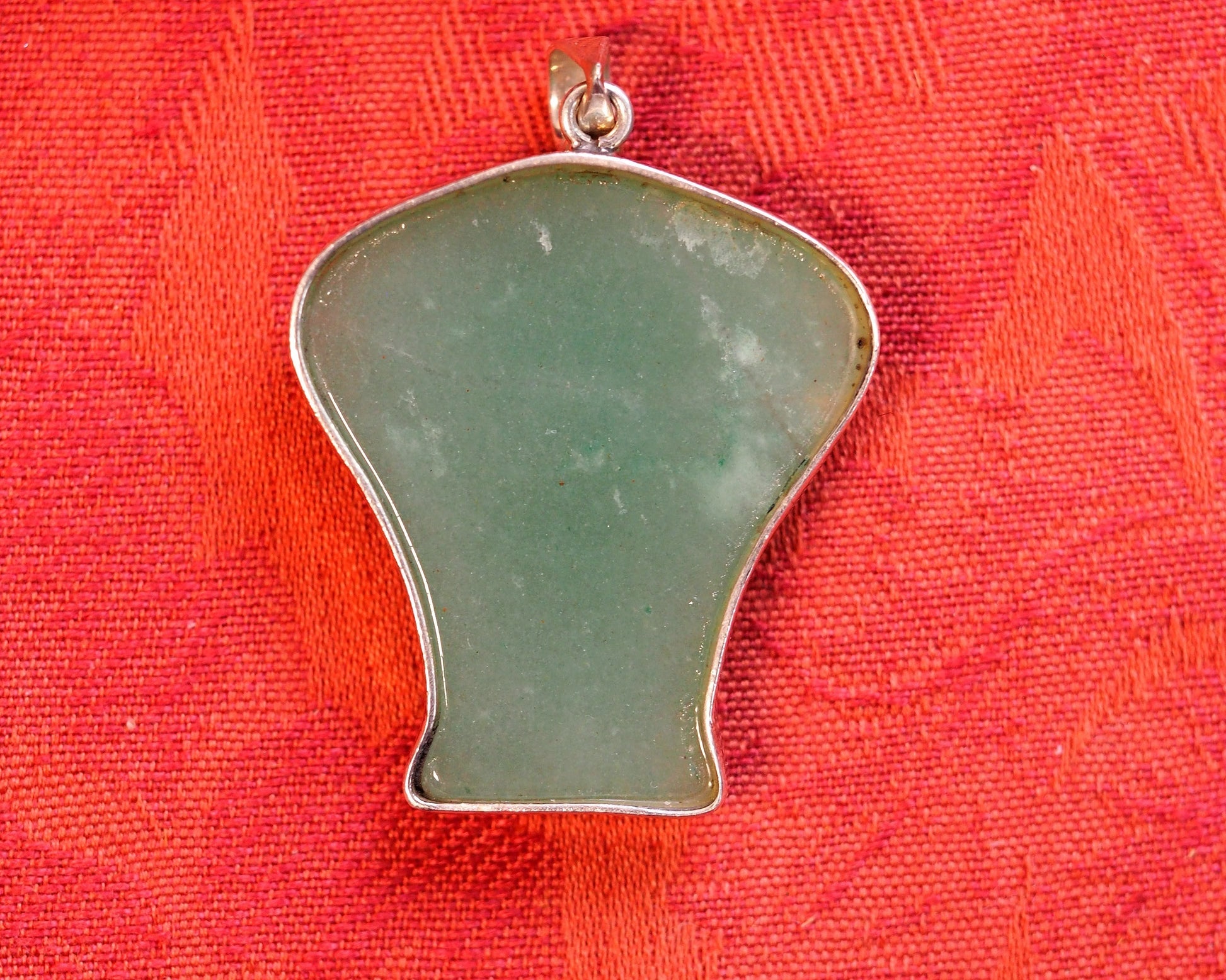 Back view of the aventurine elephant pendant showing smooth polished stone surface and sterling silver slide bail stamped 925
