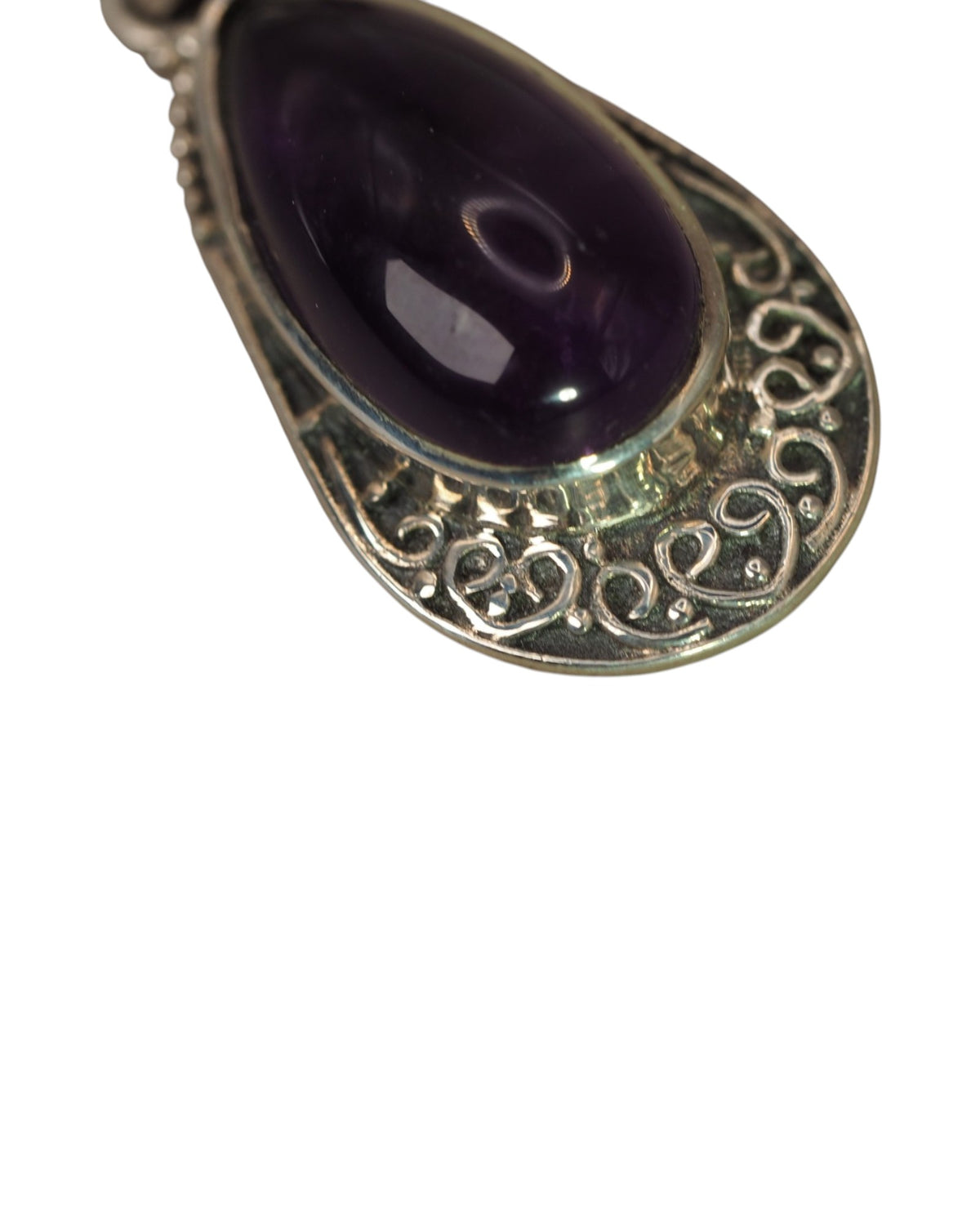 Close-up of amethyst cabochon showing color depth and natural inclusions