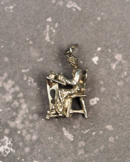 800 silver lacemaker charm showing woman seated at table, front three-quarter view