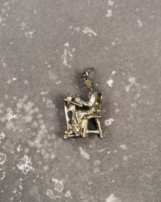 800 silver lacemaker charm showing woman seated at table, front three-quarter view