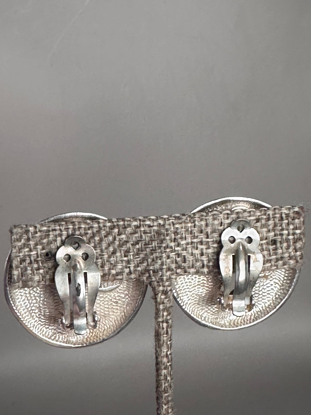 back view of sterling silver celestial clip earrings showing stippled texture and hinged clip-on mechanisms