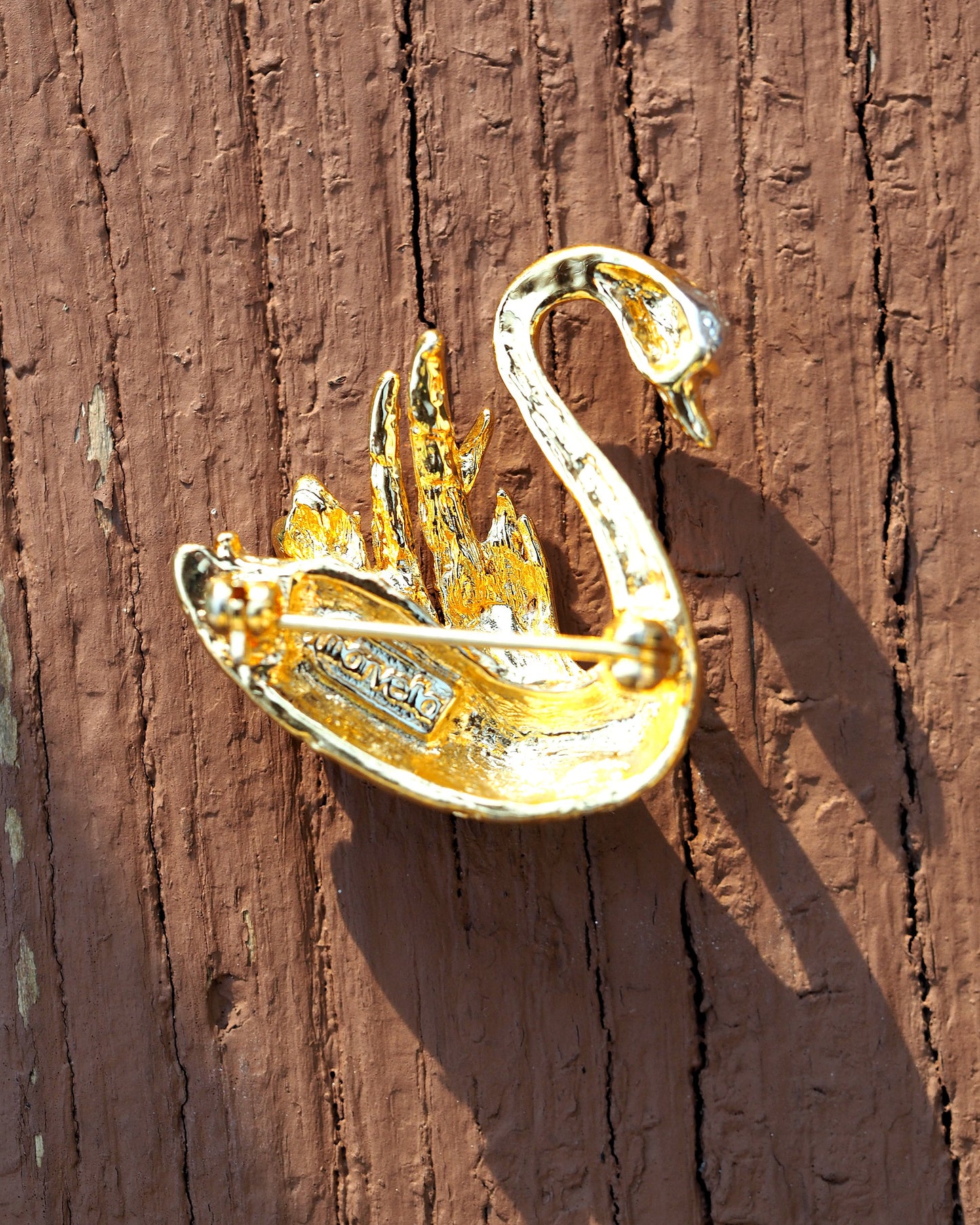Back view of Marvella swan brooch showing pin back and signature stamp