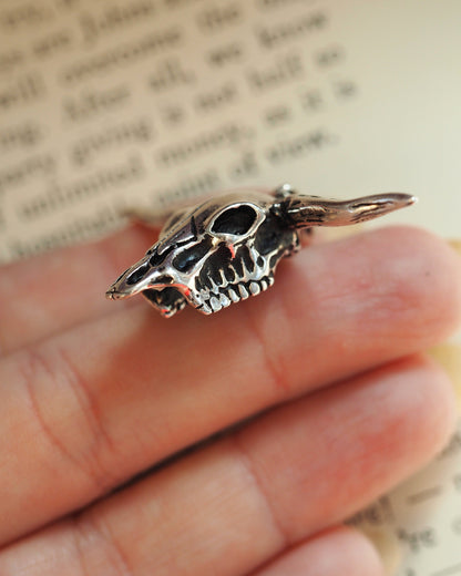 Side profile of the sterling silver longhorn skull pendant showing dimensional relief and ribbed bail