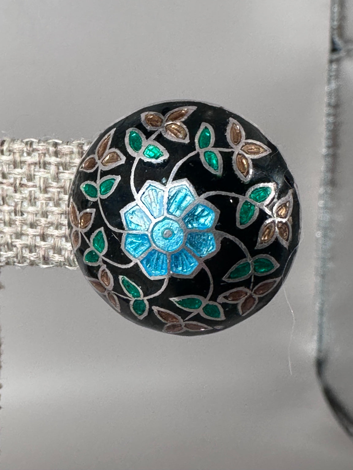 Close view of vintage black enamel floral sterling stud earring