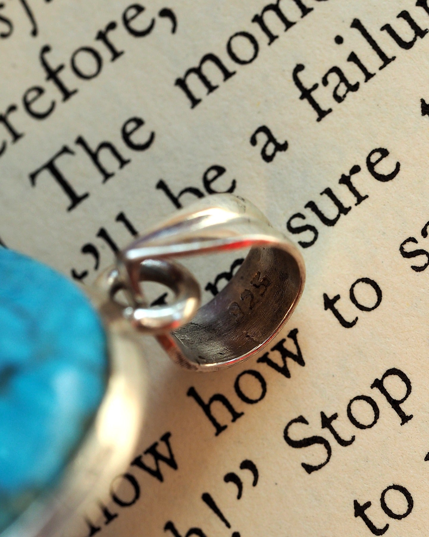 Close-up of 925 sterling silver hallmark stamped on pendant bail