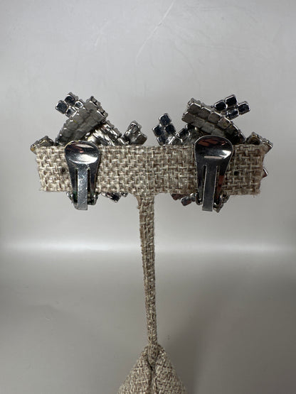 Reverse view of clip earrings showing paddle-style clip mechanisms and open-back prong settings