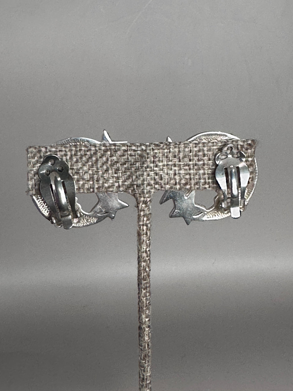 Back view of Taxco celestial clip earrings showing clip-on findings with comfort pads