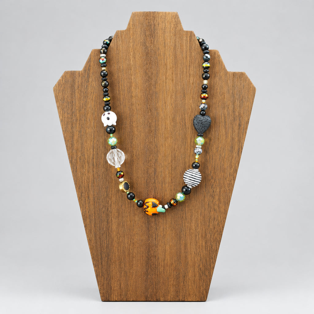 GlamGram Original Halloween ghost and pumpkin glass bead necklace on a wood necklace stand