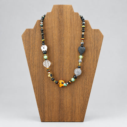 GlamGram Original Halloween ghost and pumpkin glass bead necklace on a wood necklace stand