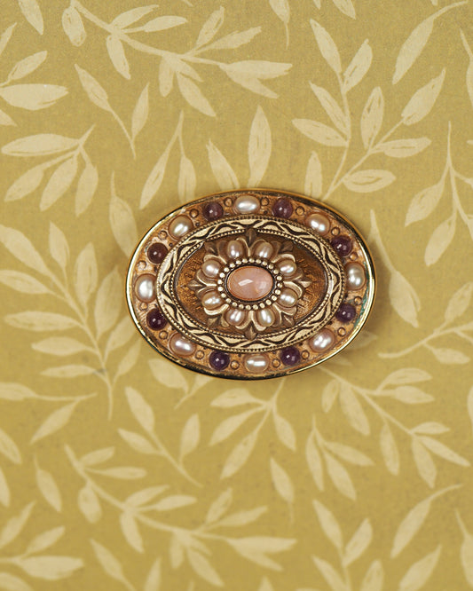 Signed Michal Golan gold-tone brooch with rose-colored quartz center, pearl-like petals, and purple accents, front view