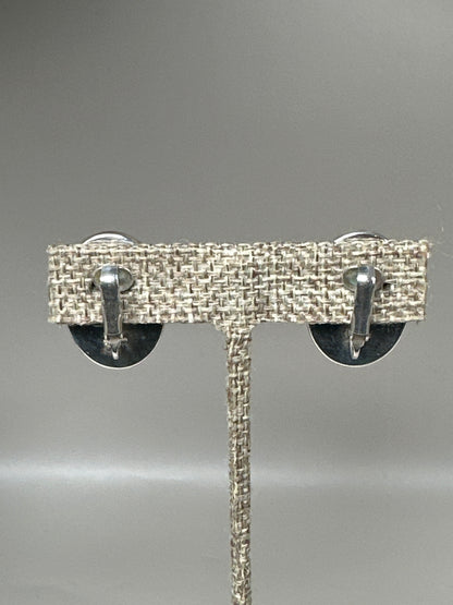 Earring backs showing hinged clip-on mechanisms with tension springs