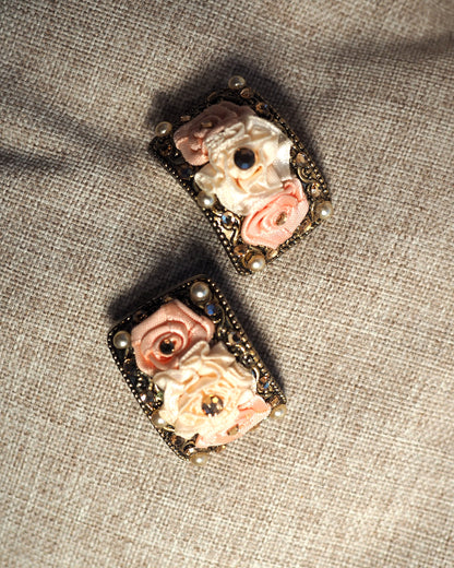 Reverse view of clip earrings showing antiqued gold-tone hinged clip-on backs