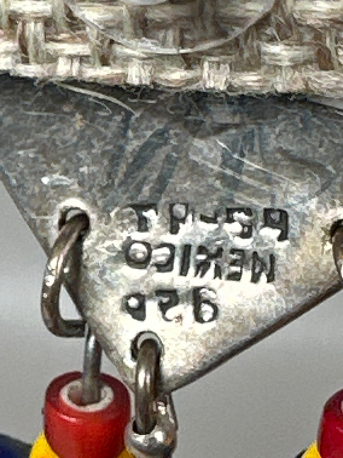 Close-up of TS-59 MEXICO 925 hallmark stamped on back of sterling silver heart earring