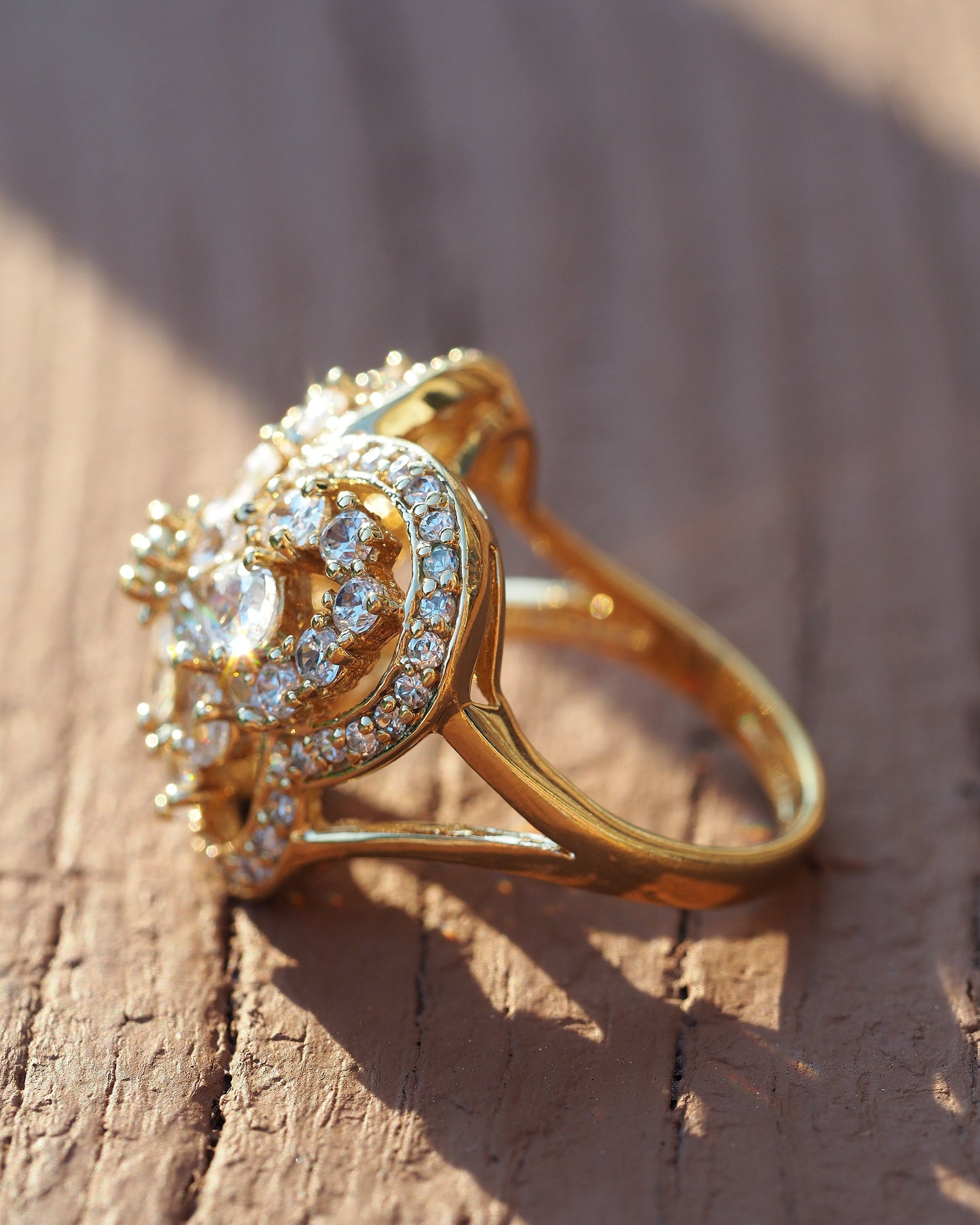 Side angle view of gold vermeil butterfly ring showing dimensional construction and prong-set rhinestones