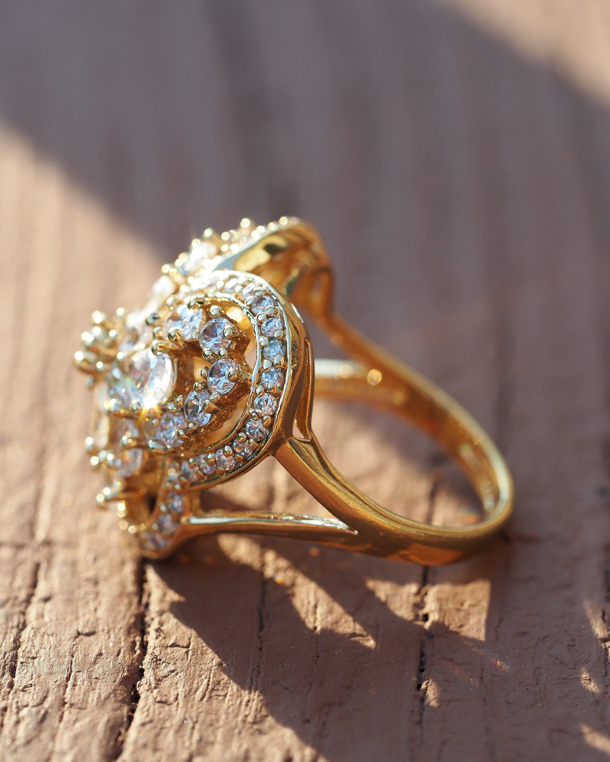 Side angle view of gold vermeil butterfly ring showing dimensional construction and prong-set rhinestones