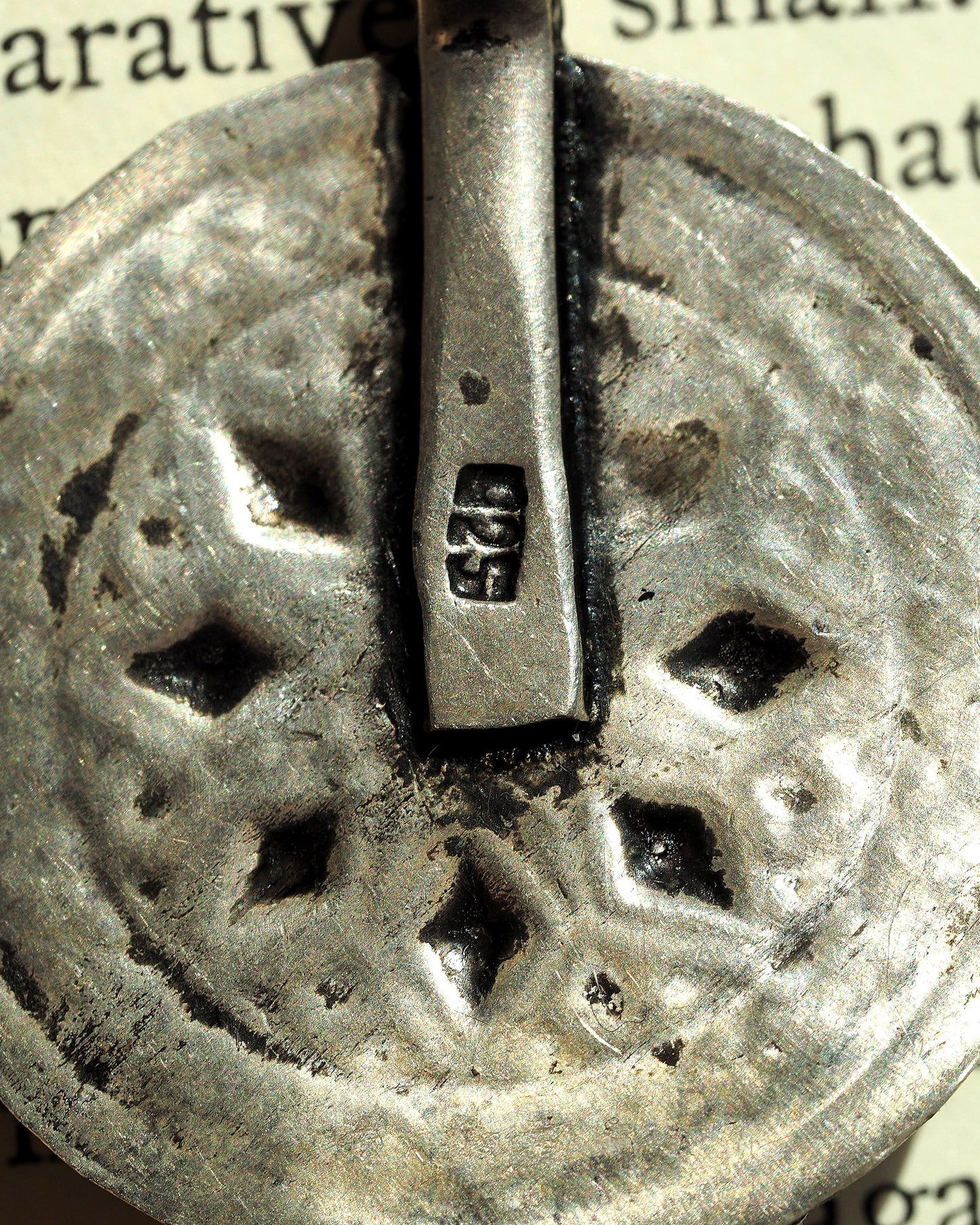 Detail of 925 hallmark stamped inside the bail channel of the elephant pendant