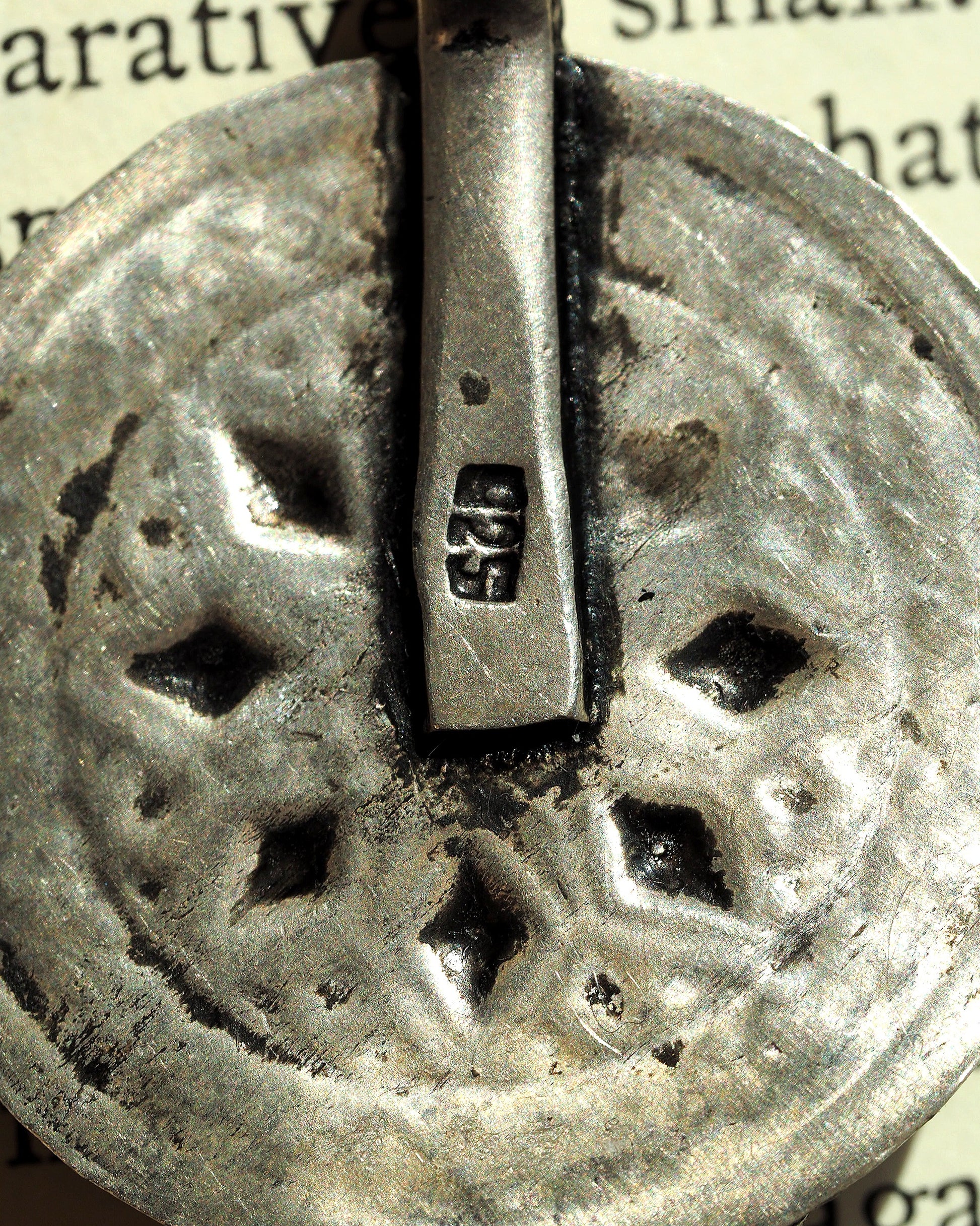 Detail of 925 hallmark stamped inside the bail channel of the elephant pendant