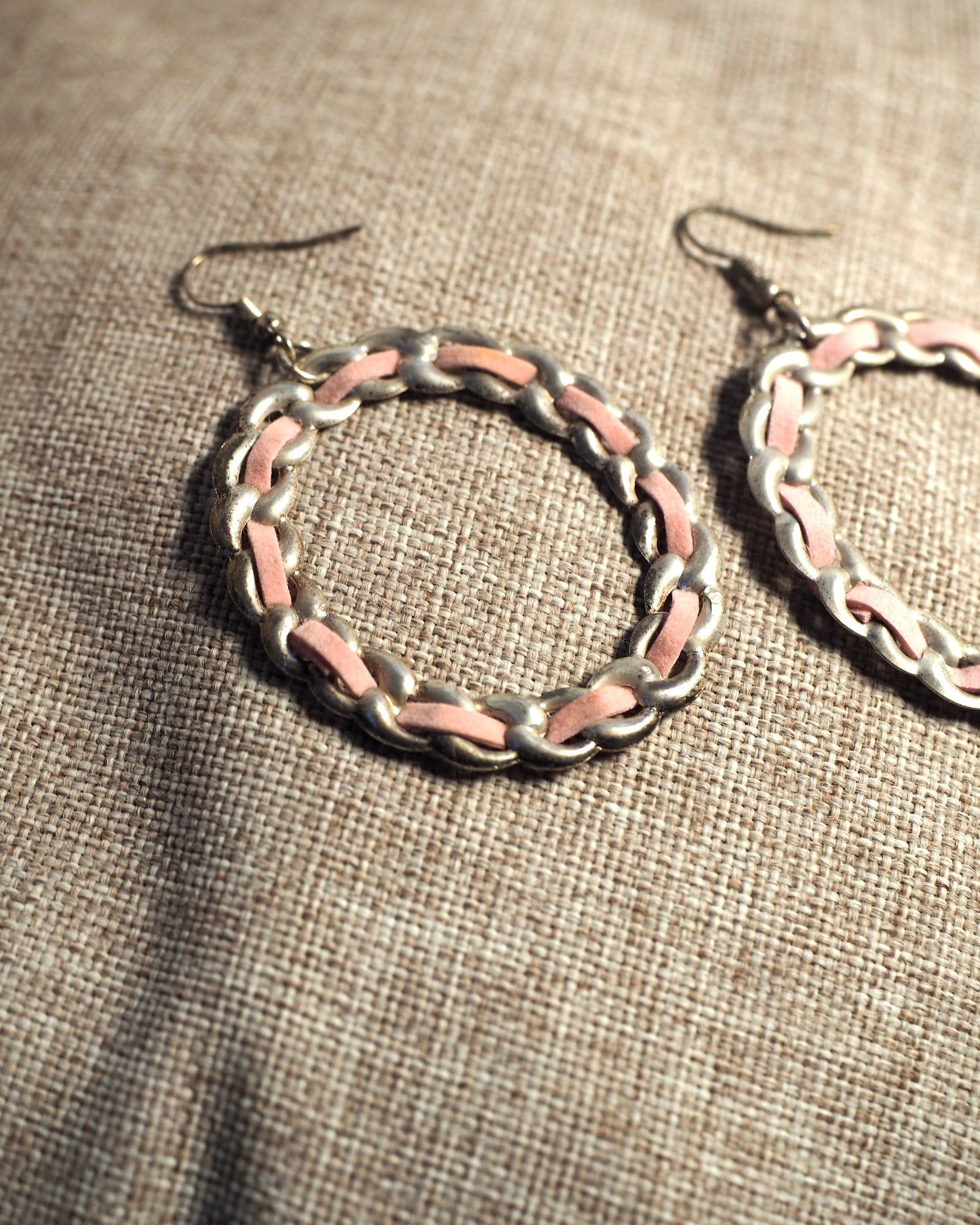 Reverse view of 1970s pink enamel chainlink hoop earrings showing wire hook closures and aged silver-tone finish