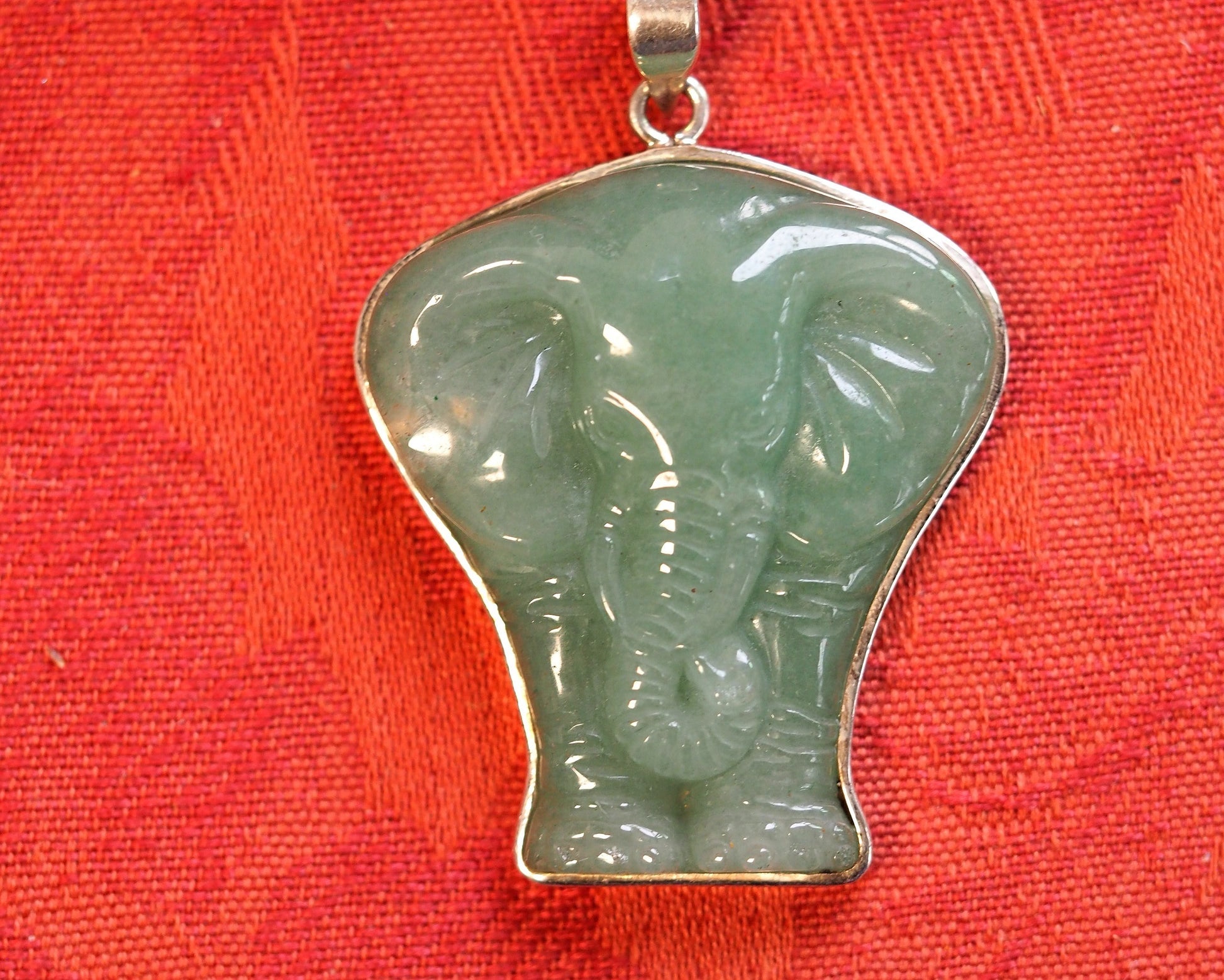 Sterling silver aventurine elephant pendant in pale sage-green, carved silhouette with raised trunk and fanned ears, front view