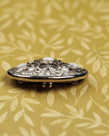 Side profile of Michal Golan oval brooch showing openwork construction and pin clasp