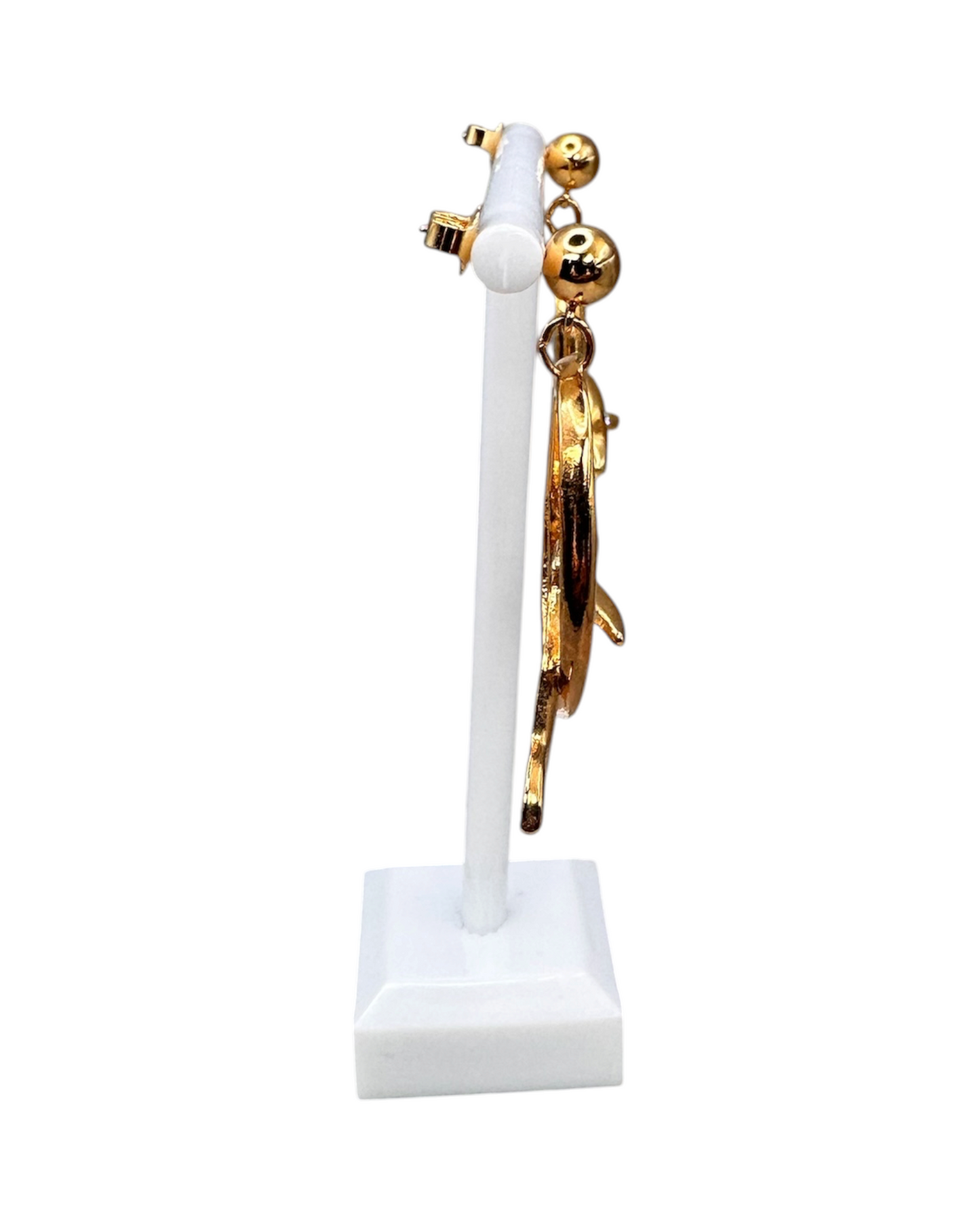 Side view of single Avon dolphin earring on white stand showing post back and full drop length
