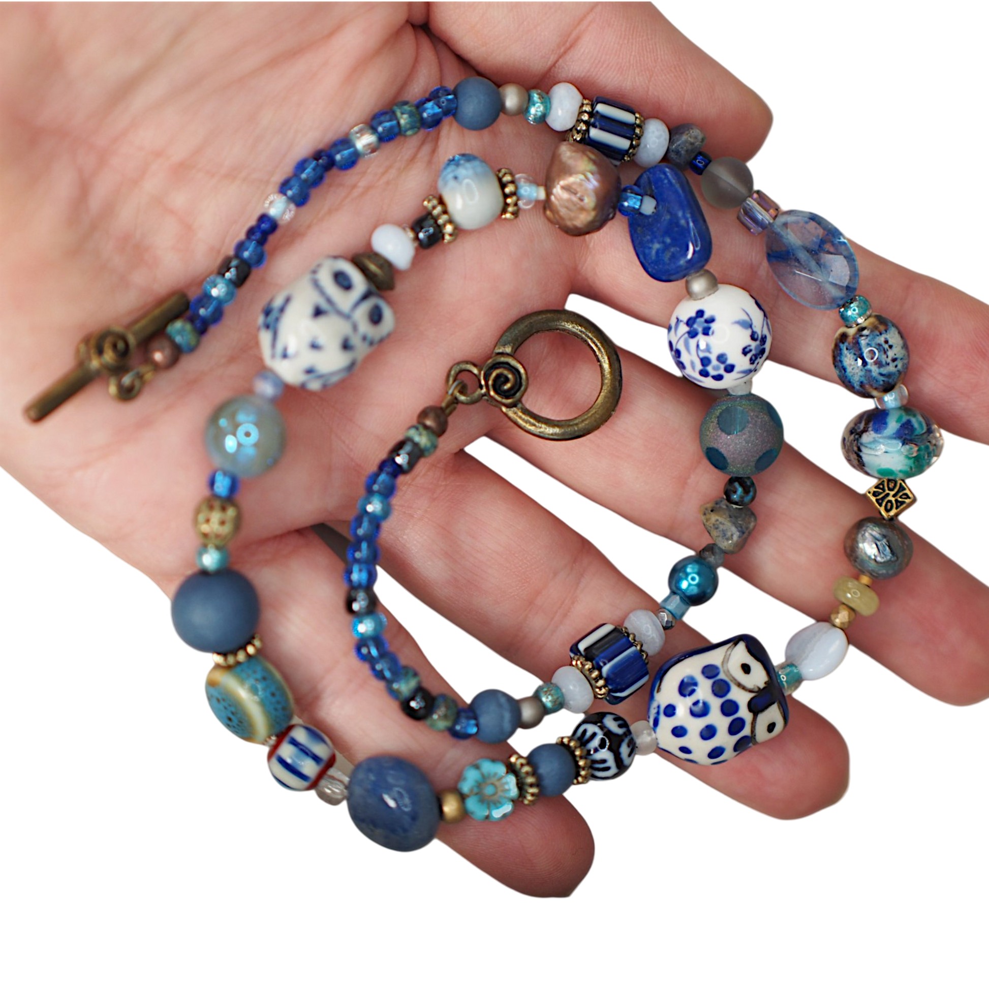 Handbeaded artisan necklace detail, ceramic and vintage beads in blues