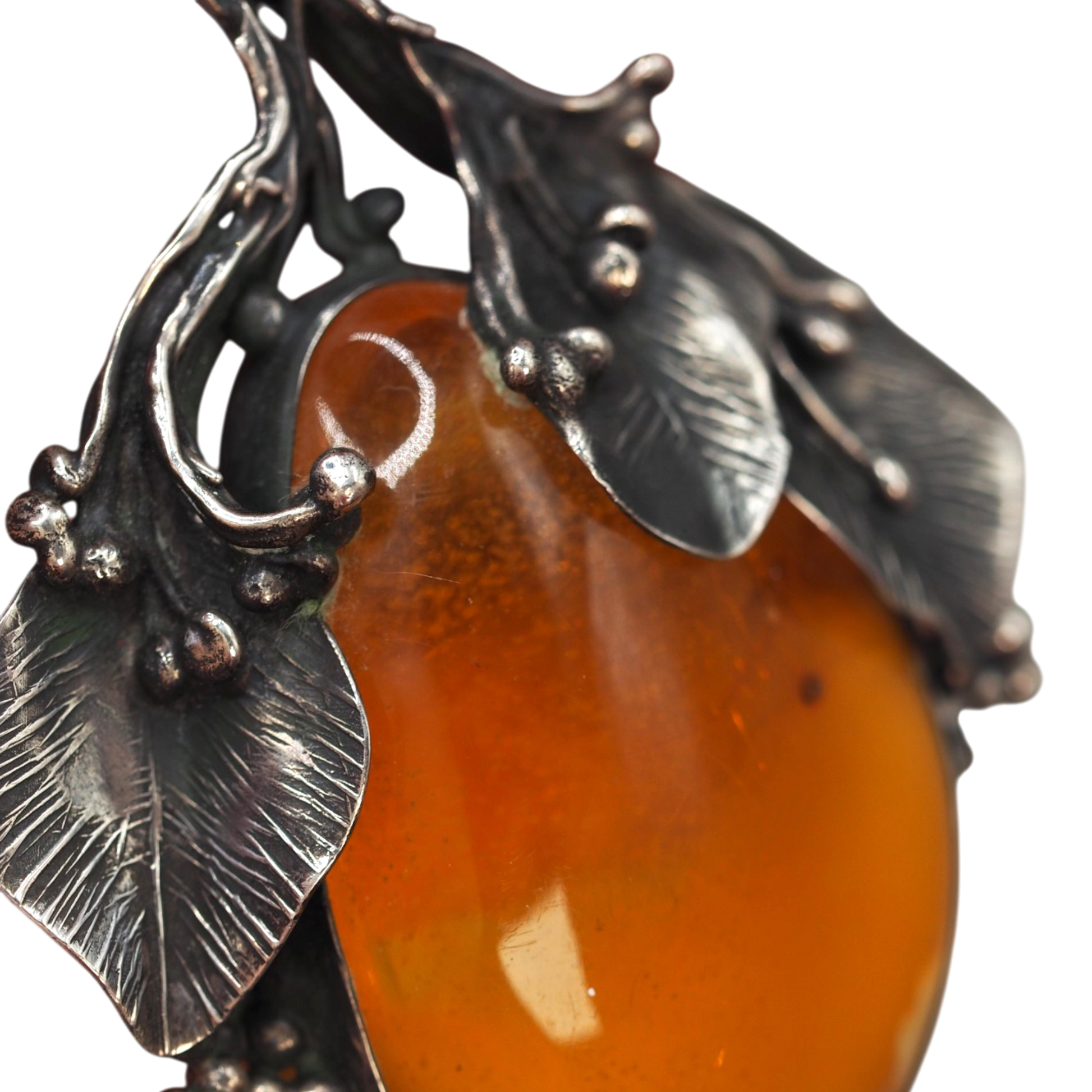 Side profile of large Baltic amber leaf pendant