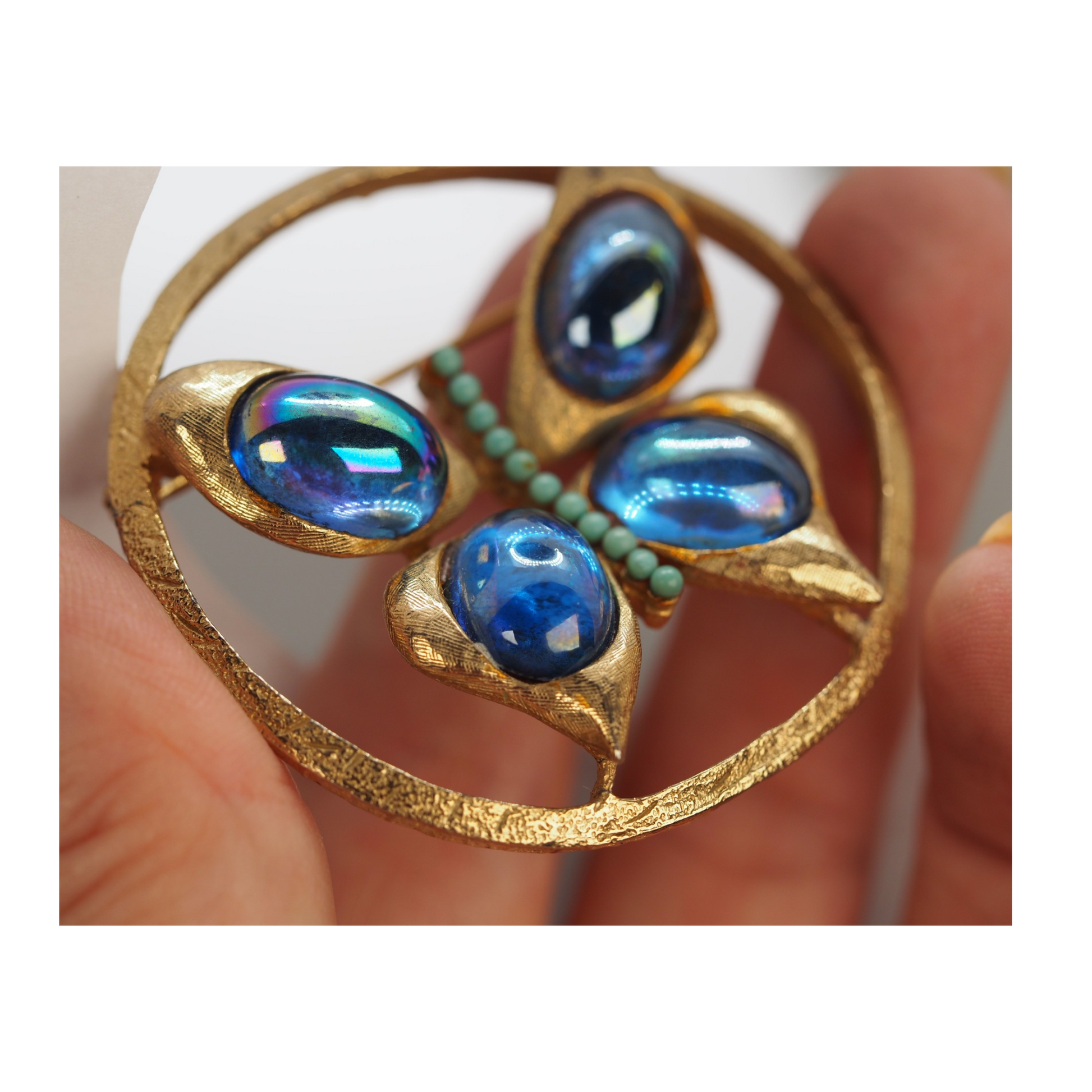 Blue art glass cabochon butterfly brooch with open circular wing design