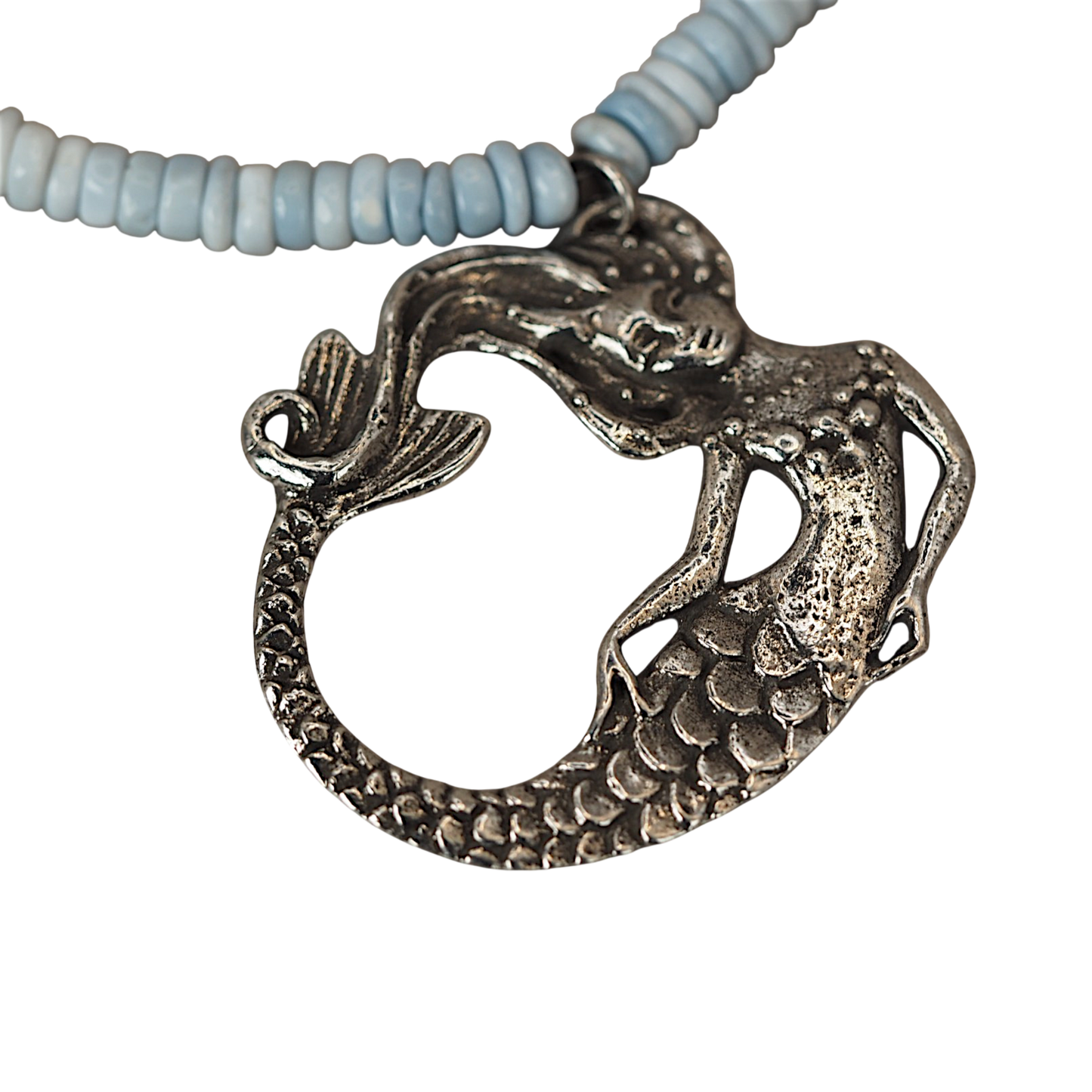 Close up of Green Girl Studios pewter mermaid focal on an opal bead necklace