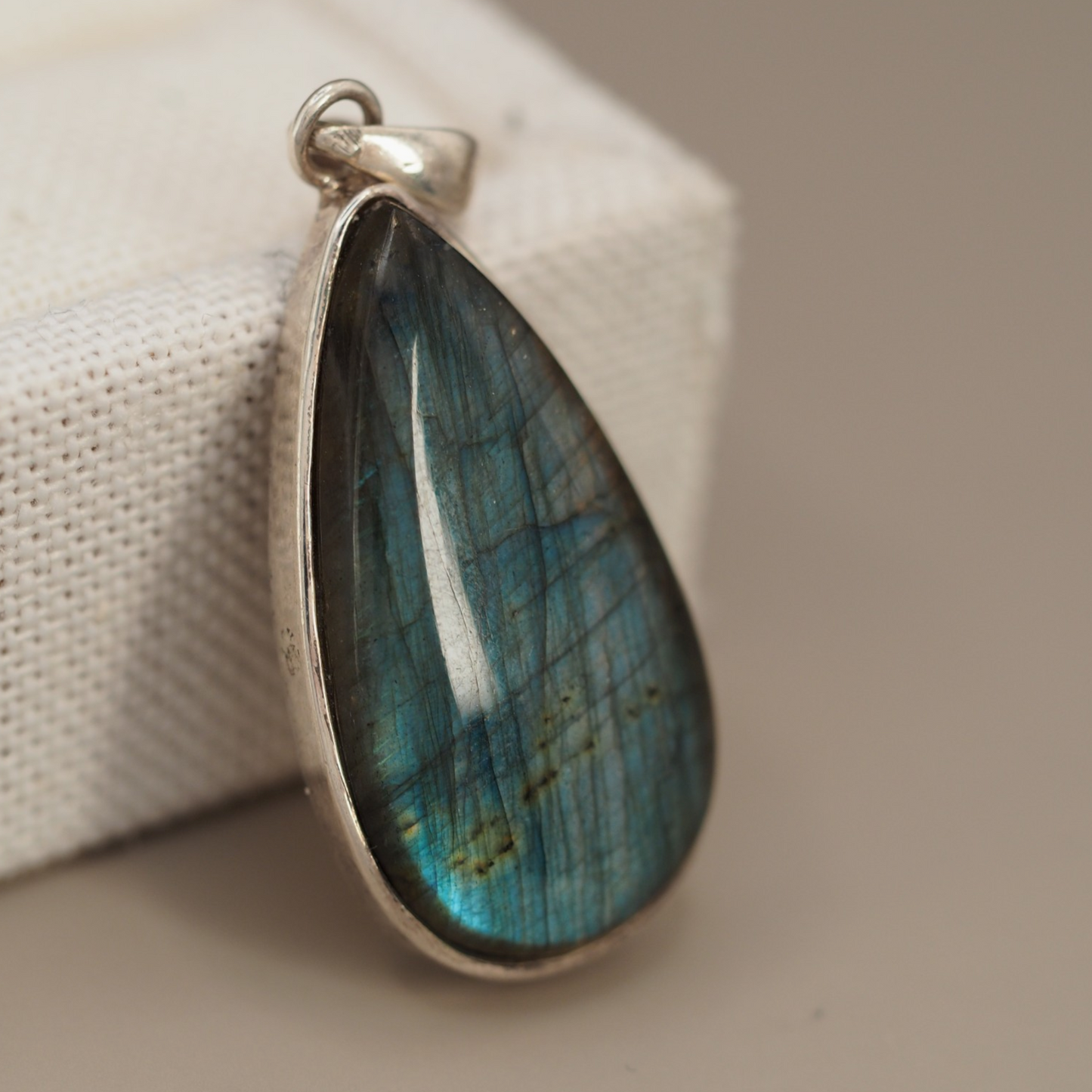 Electric blue labradorite cabochon and sterling bezel close-up