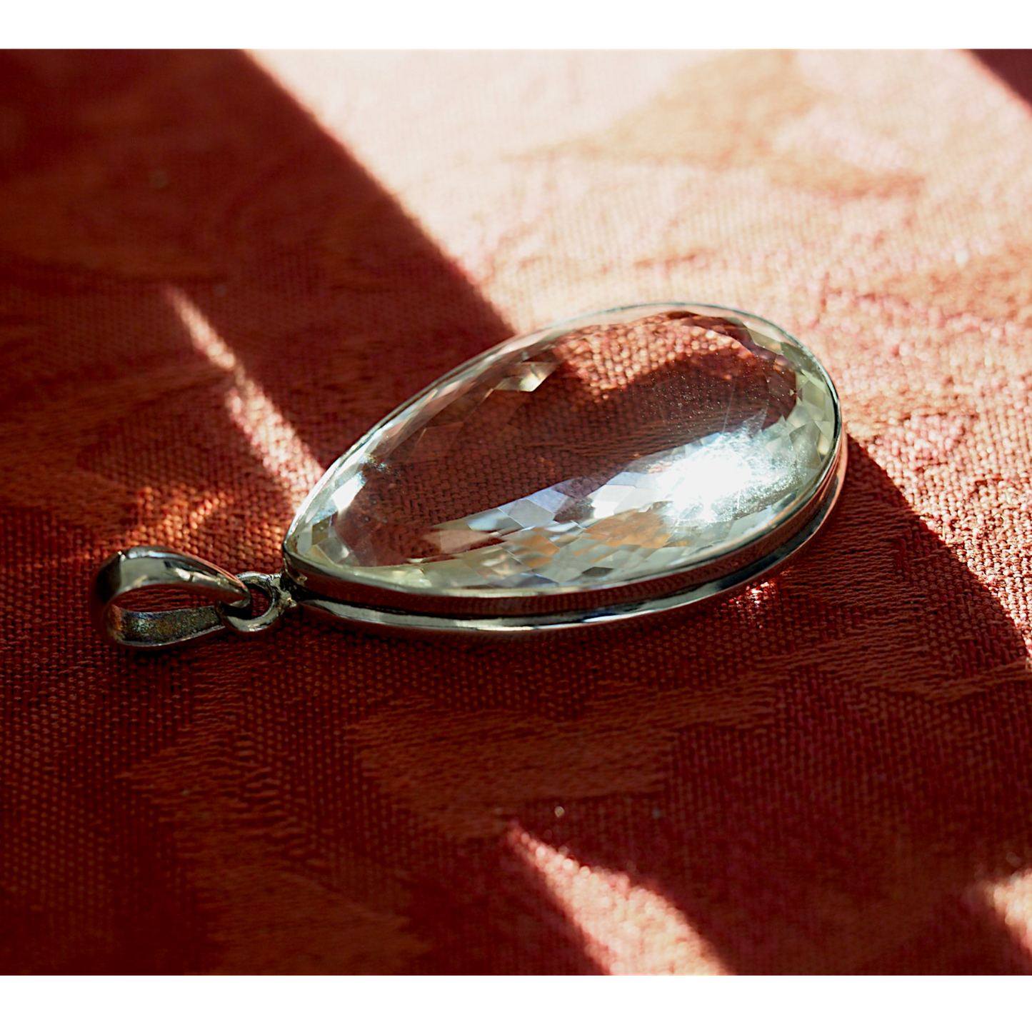 Sterling silver clear faceted teardrop pendant front view