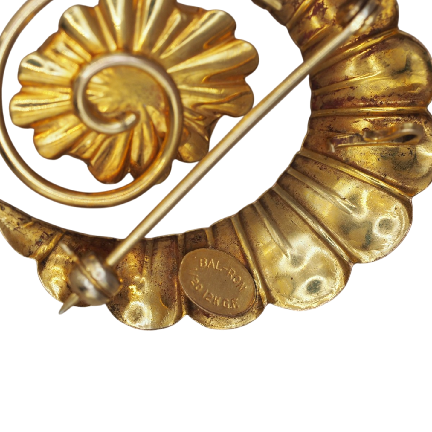 Rose gold corrugated crescent and coiled wire spiral on a Bal-Ron shell cameo brooch