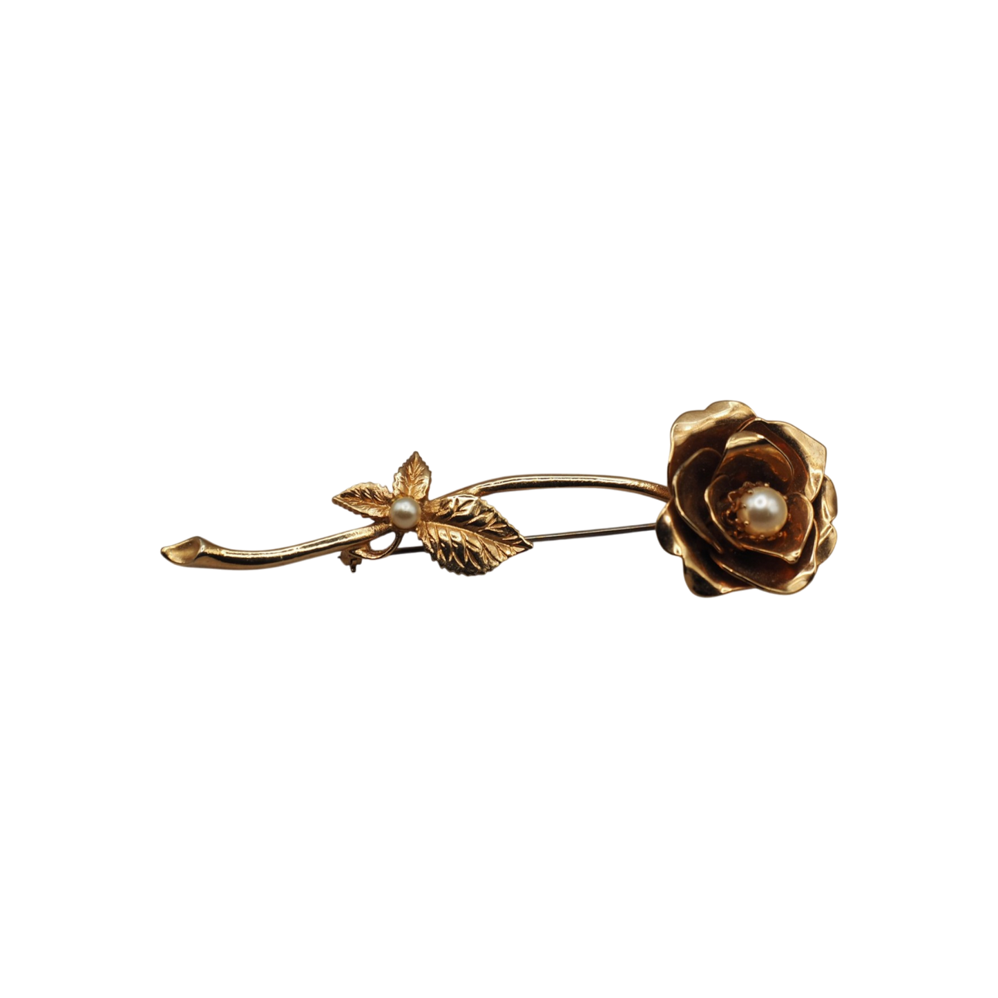 Close up of a gold tone sculptural rose brooch with a faux pearl