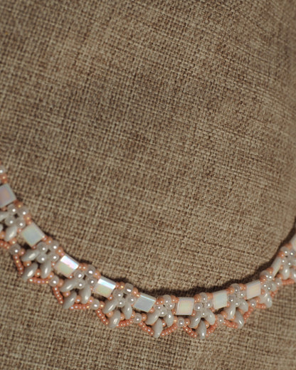 Lower section of collar necklace on burlap showing consistent beadwork pattern and spacing