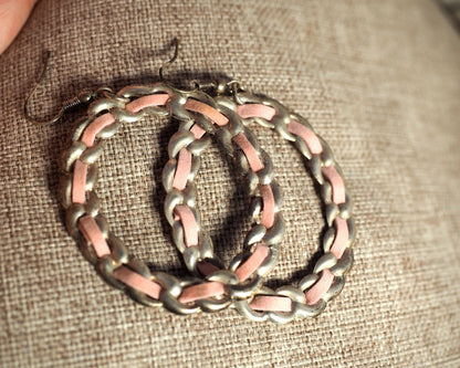 1970s pink enamel chainlink hoop earrings resting on fingertips, showing scale and 2 3/4 inch drop length