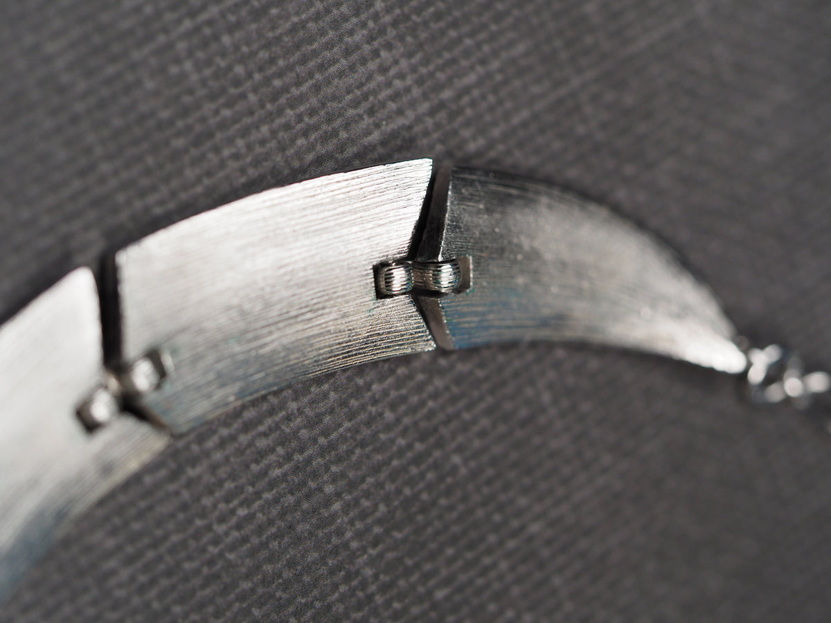Brushed silver-tone Trifari collar necklace laid flat