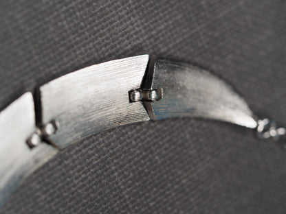 Brushed silver-tone Trifari collar necklace laid flat