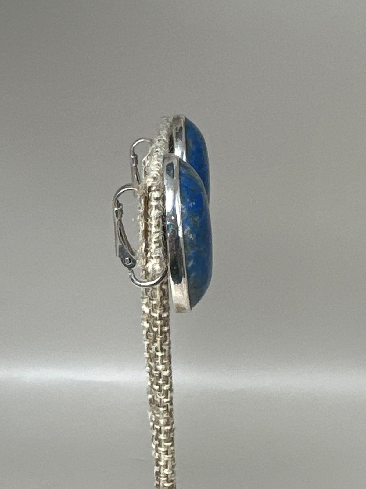 Close-up side angle showing bezel construction and lapis stone profile