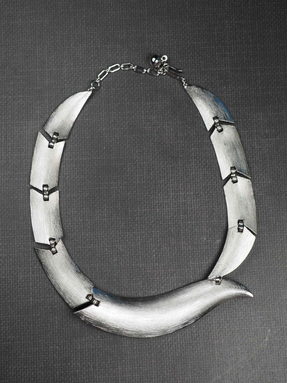 Signed Trifari modernist collar necklace with brushed silver-tone curved links, front view