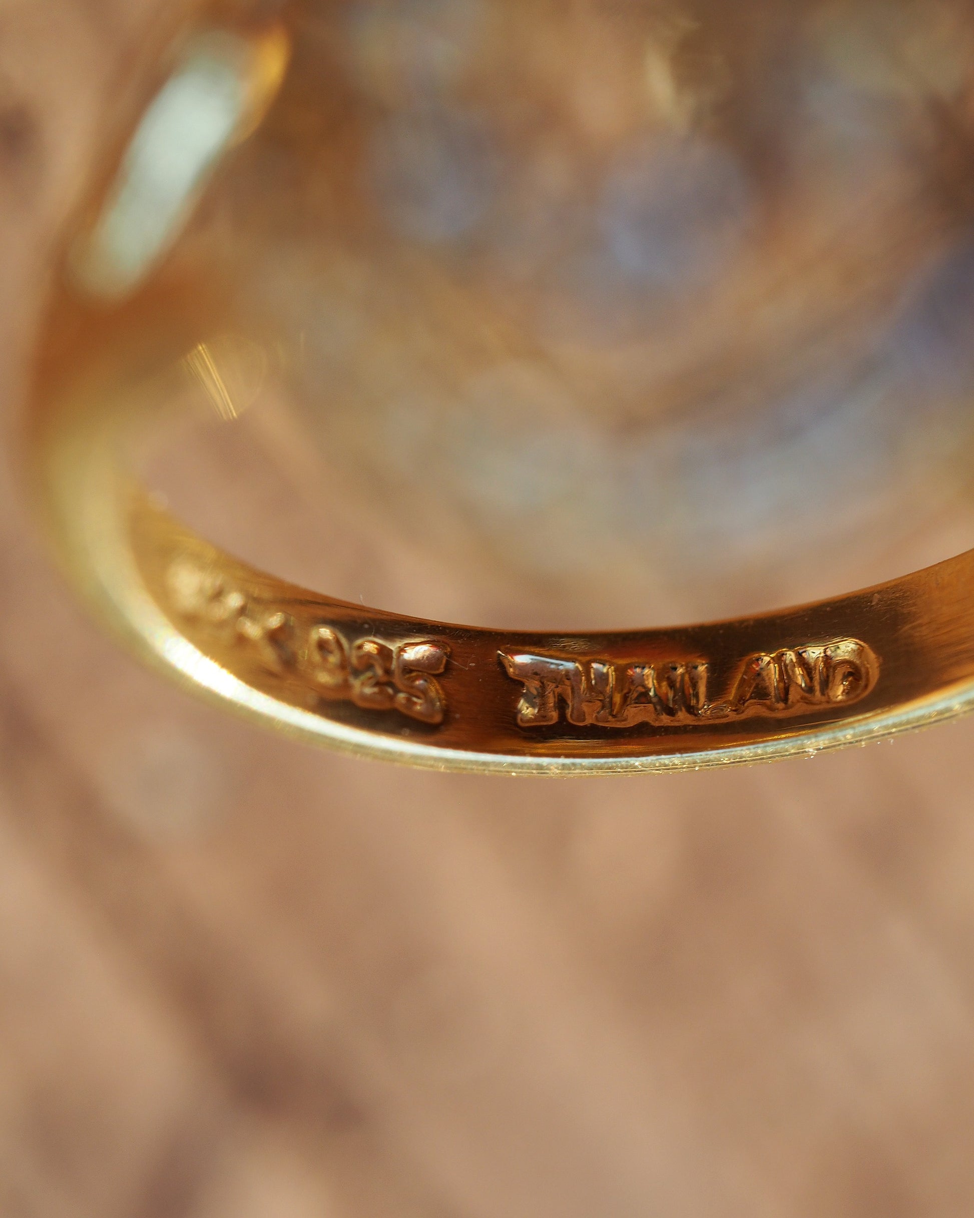 Close-up of interior band stamp reading '9 to 14 karat 19 to five in Thailand'