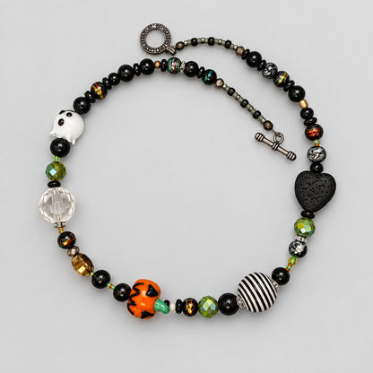 GlamGram Original Halloween glass bead necklace with white ghost bead, orange pumpkin, black lava heart and toggle clasp, full view