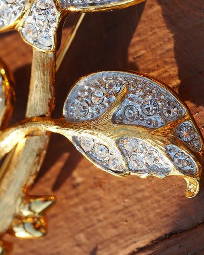 Close-up of rhinestone-pavéd rose petals with graduated clear stones in gold-tone channels